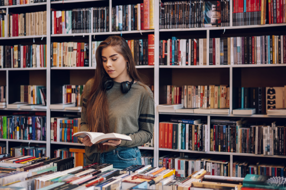 Warm independent bookstore interior with wood shelves filled with books